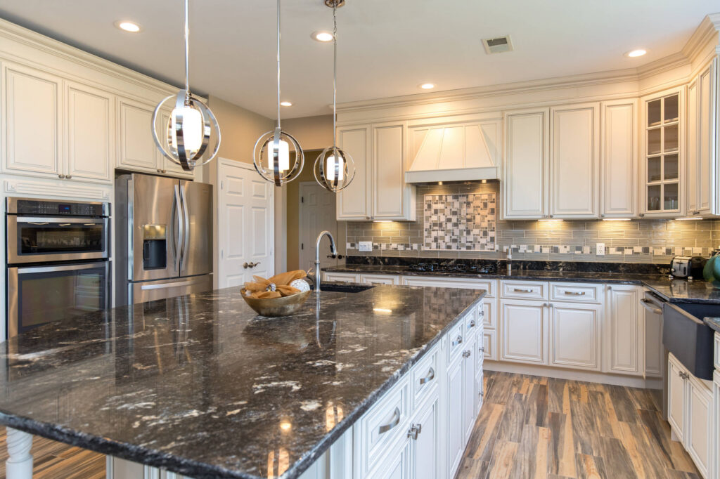 Bright Dulles kitchen renovation with updated cabinets, countertops, backsplash, and lighting
