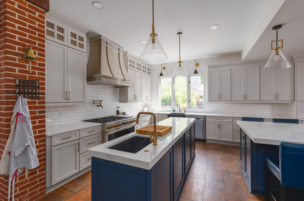 High-end kitchen remodel with wood cabinetry, premium countertops, modern appliances, and pendant lighting