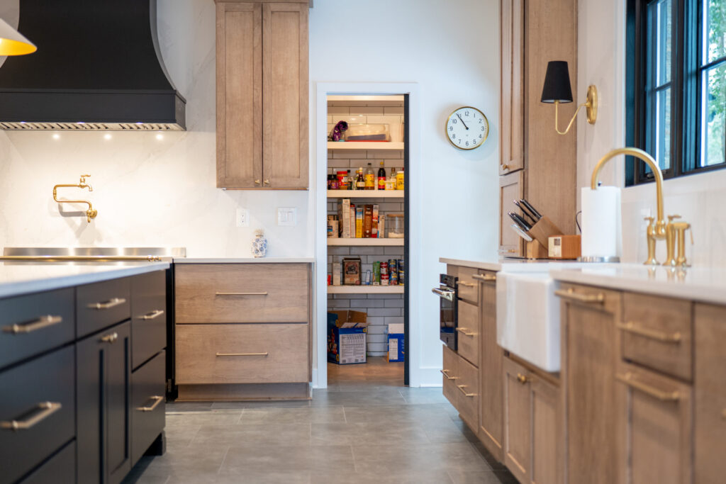 White oak kitchen cabinets with an adjoining walk-in pantry for extra food and kitchen storage